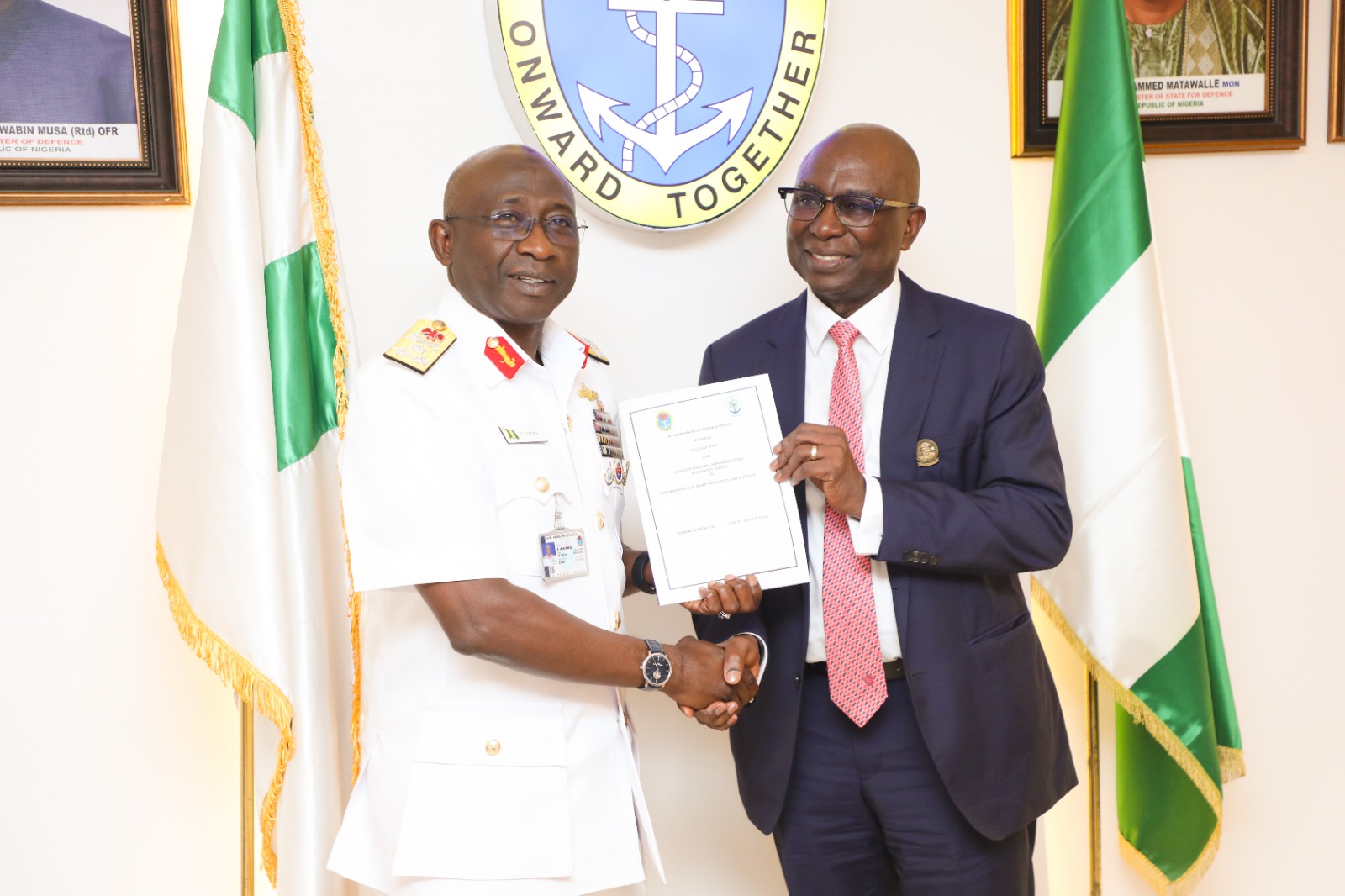 DG NIMASA, Dr Dayo Mobereola and the Chief of the Naval Staff, Vice Admiral Idi Abbass holding a copy of the MOU between NIMASA/NAVY at the Naval HQ in Abuja.